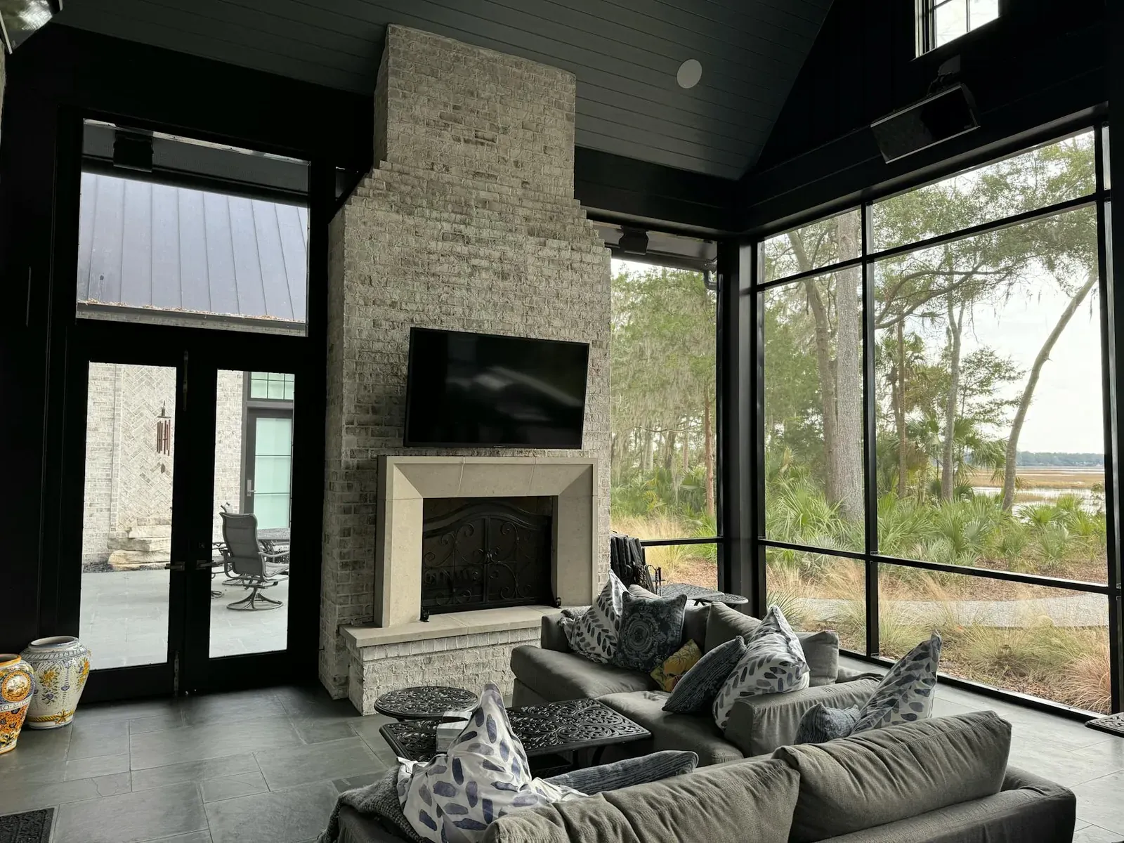 Cozy modern living room in Bluffton, SC featuring a fireplace and outdoor view.