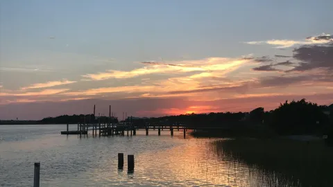 A beautiful sunset at a dock in Myrtle Beach, capturing the reflection on calm waters.