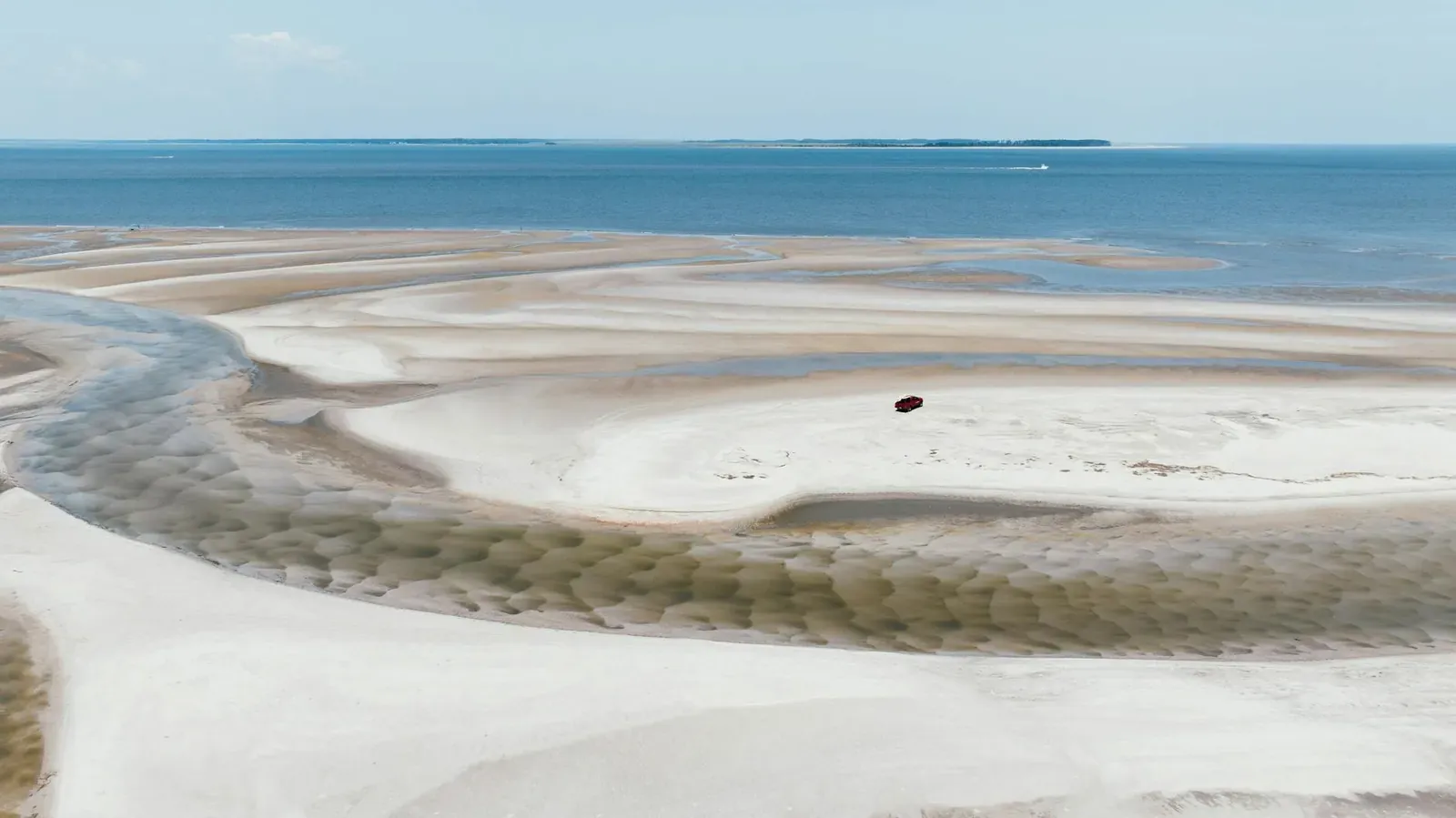 Stunning aerial shot of the sandy beach and ocean at Hilton Head Island, showcasing intricate patterns and serene beauty