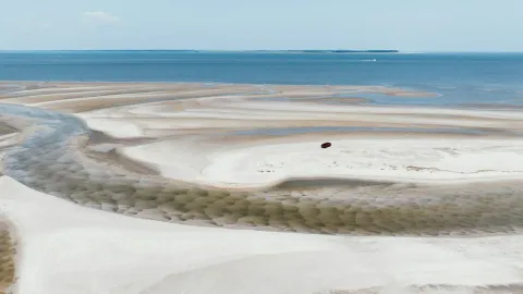 Stunning aerial shot of the sandy beach and ocean at Hilton Head Island, showcasing intricate patterns and serene beauty