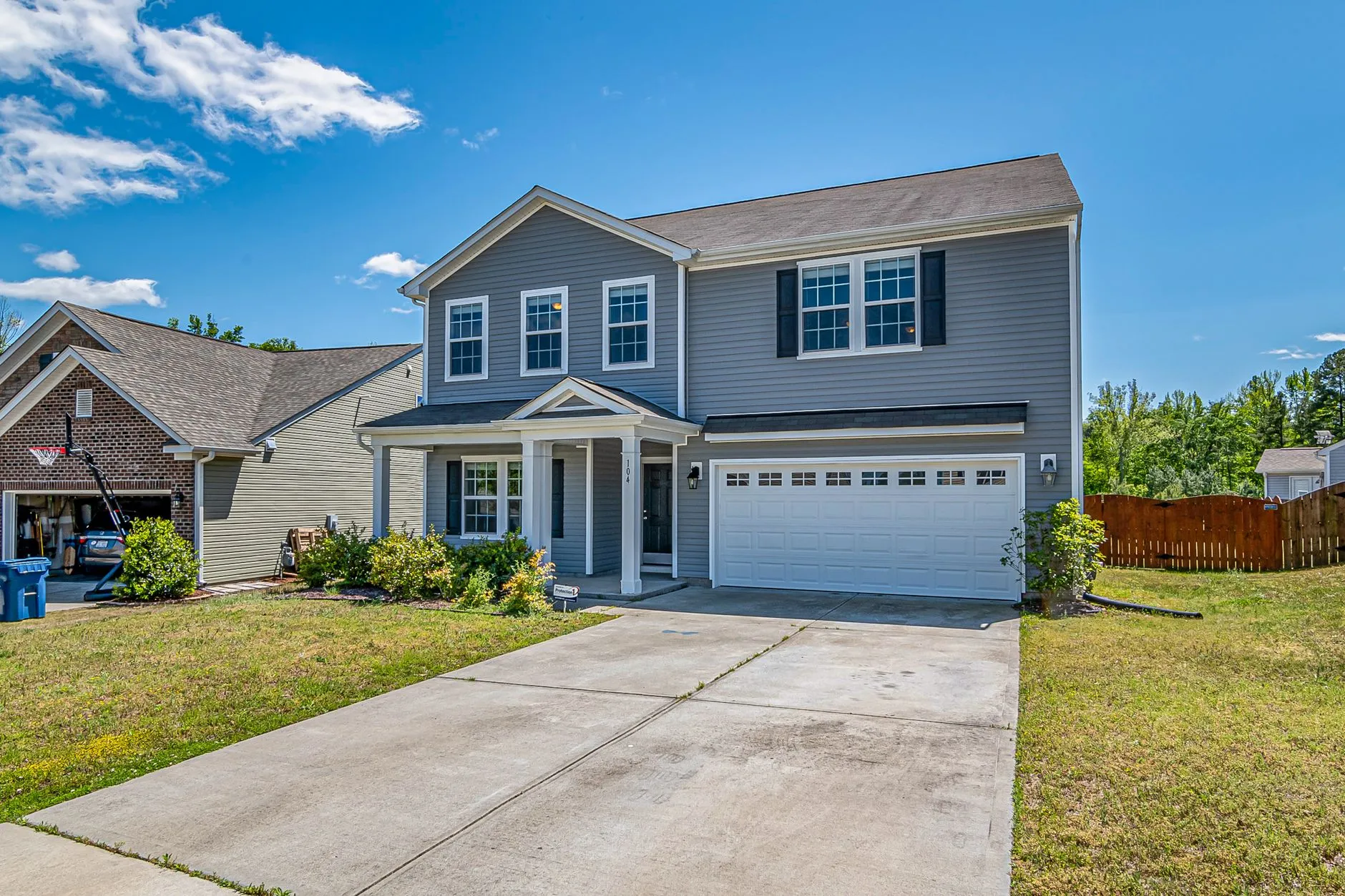 Spacious two-story house with attached garage in a peaceful neighborhood.